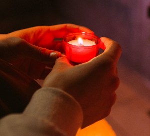 hands holding candle