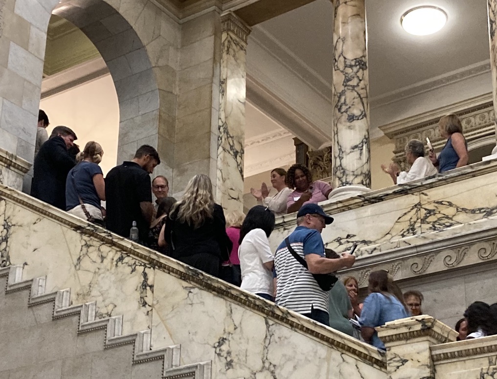 Citizens line halls and stairways at Massachusetts State House to deliver petitions