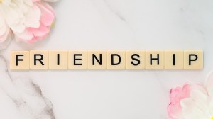 the word "friendship" spelled out in letters on wooden tiles
